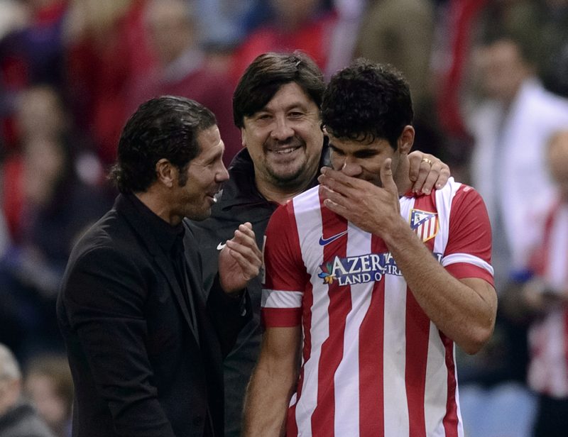 Atletico Madrid's coach Diego Simeone (L) greets Atletico Madrid's Brazilian forward Diego da Silva Costa (R) during the Spanish league football match Club Atletico de Madrid vs Betis at the Vicente Calderon stadium in Madrid on October 27, 2013. AFP PHOTO/ DANI POZO (Photo credit should read DANI POZO/AFP/Getty Images)