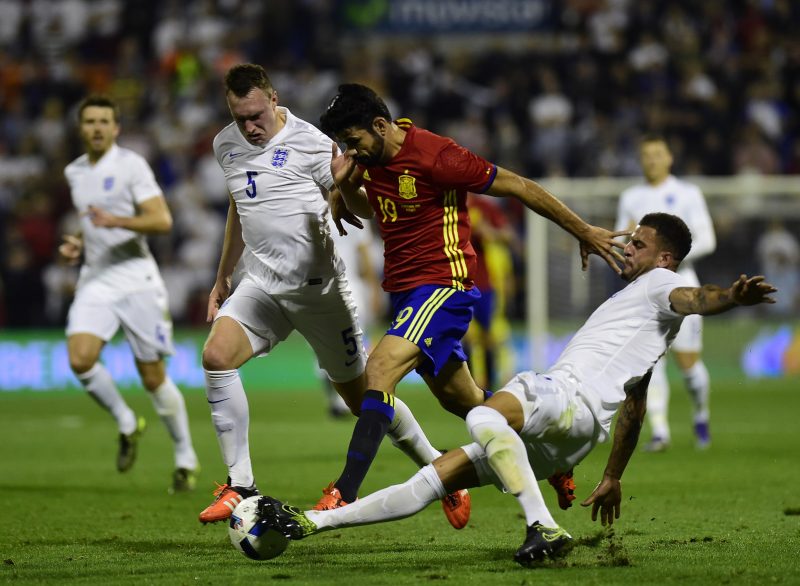 Spain's forward Diego Costa (C) vies with England's defender Phil Jones (L) and England's defender Kyle Walker (R) during the friendly football match Spain vs England at the Jose Rico Perez stadium in Alicante on November 13, 2015. AFP PHOTO/ PIERRE-PHILIPPE MARCOU (Photo credit should read PIERRE-PHILIPPE MARCOU/AFP/Getty Images)