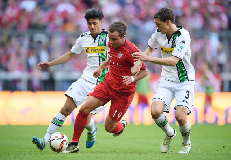 MUNICH, GERMANY - APRIL 30: Mario Goetze of Muenchen is challenged by Andreas Christensen of Gladbach during the Bundesliga match between FC Bayern Muenchen and Borussia Moenchengladbach at Allianz Arena on April 30, 2016 in Munich, Germany.  (Photo by Matthias Hangst/Bongarts/Getty Images)