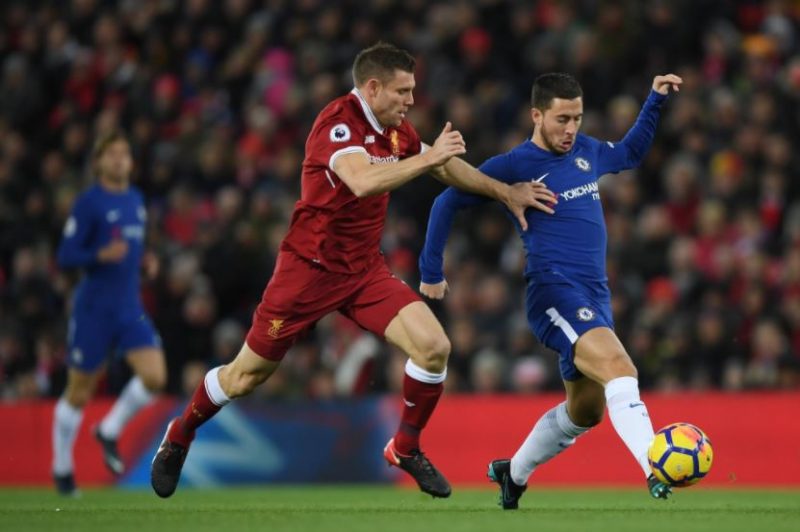 Eden Hazard runs around Liverpool's James Milner.