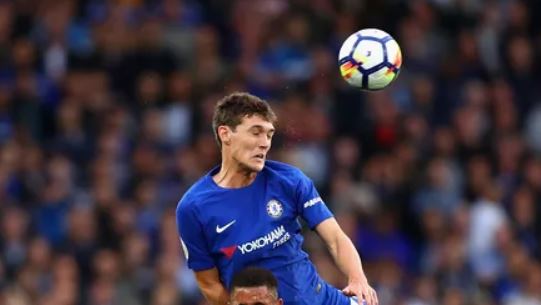 Andreas Christensen leaps to win the ball.
