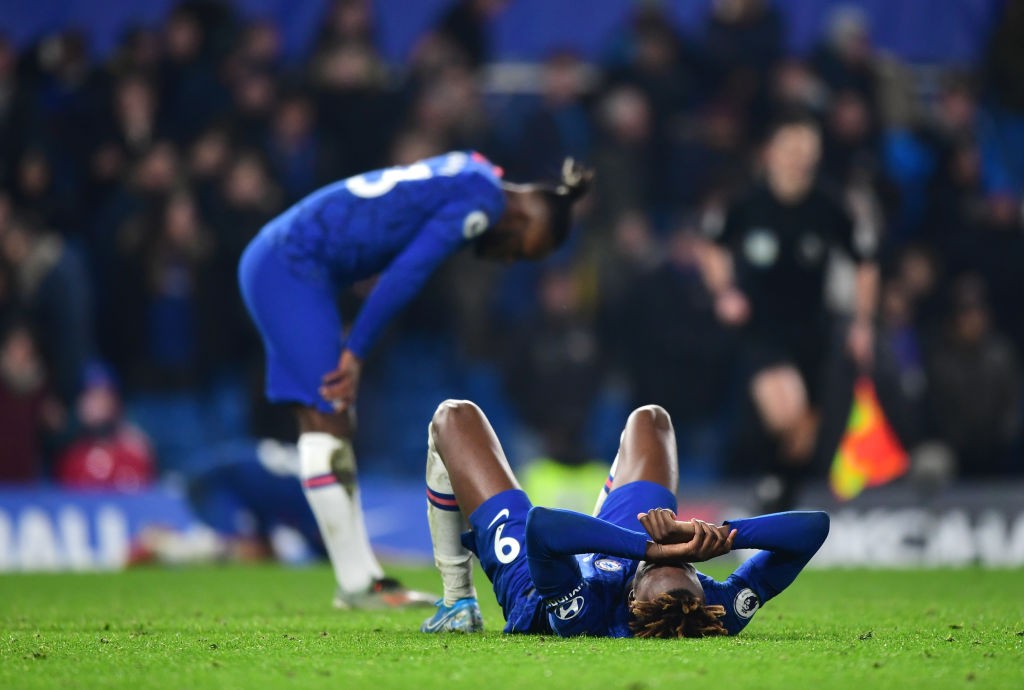 Chelsea players look sad after a defeat.