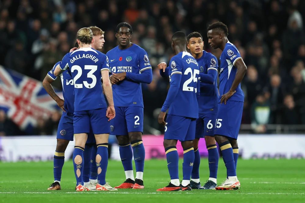Chelsea players talk on the pitch.
