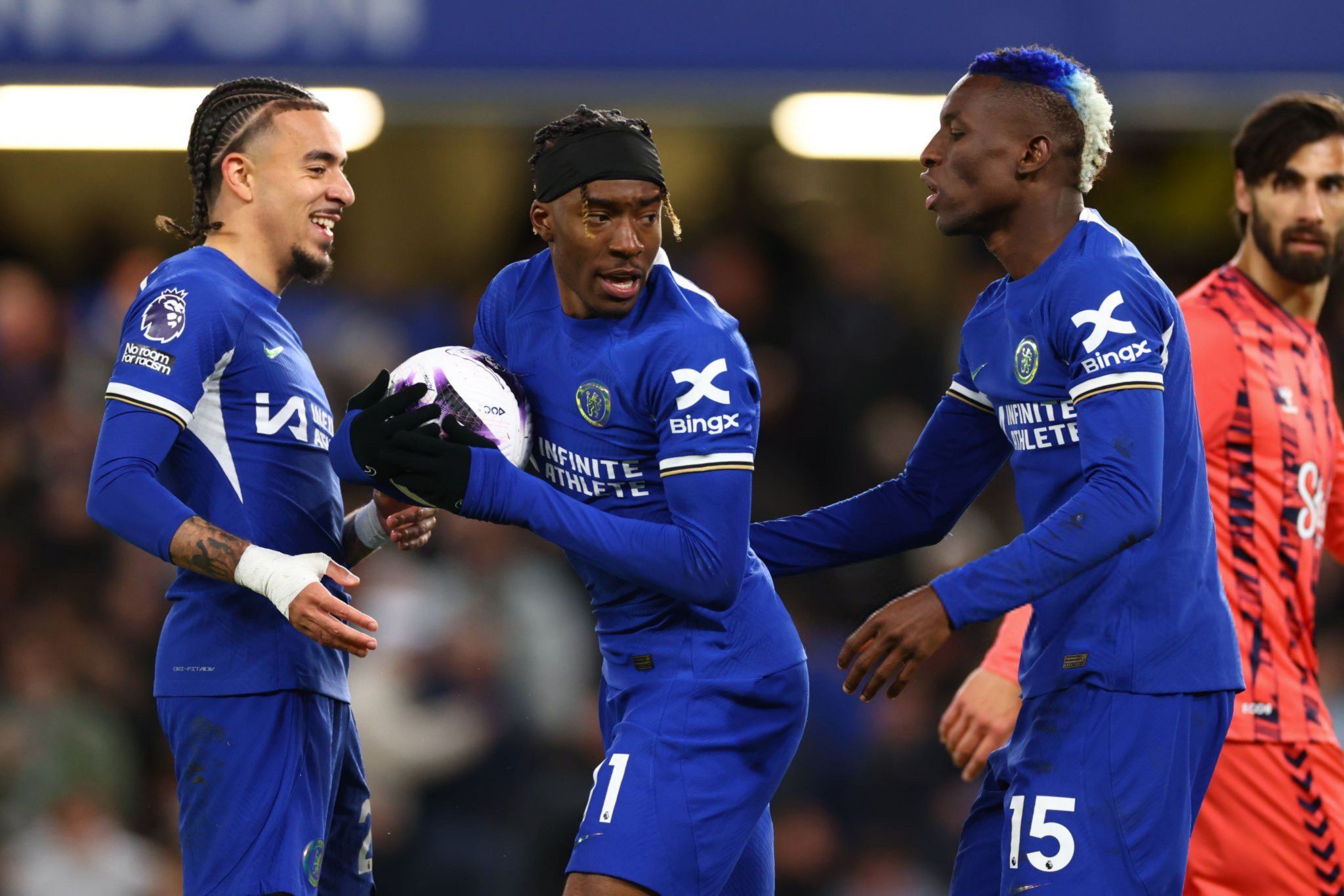 Noni Madueke argues with Nicolas Jackson about taking a penalty.