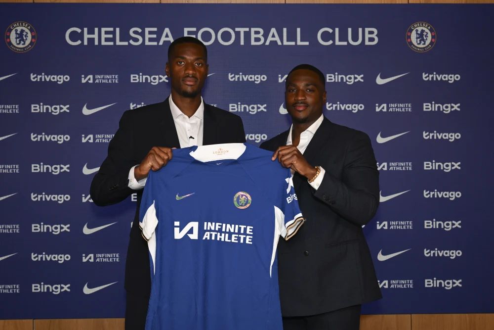 Tosin Adarabioyo holds up a shirt at Stamford Bridge.