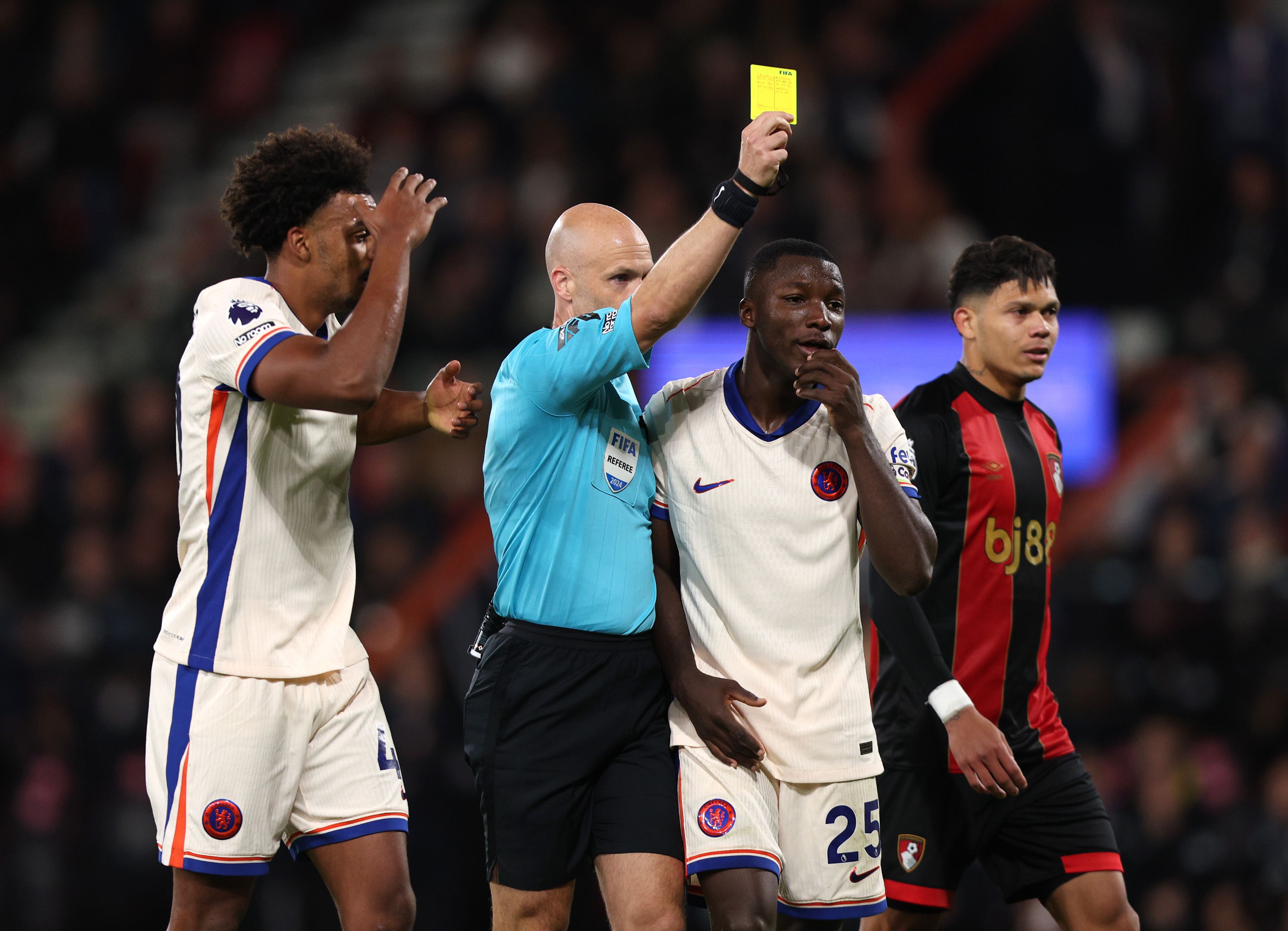 Anthony Taylor hands out a yellow to a Chelsea player. (Photo by Ryan Hiscott/Getty Images)
