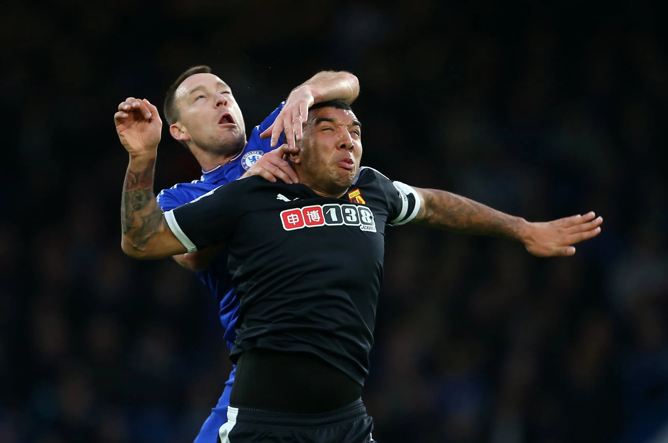 John Terry batters Troy Deeney in the air.