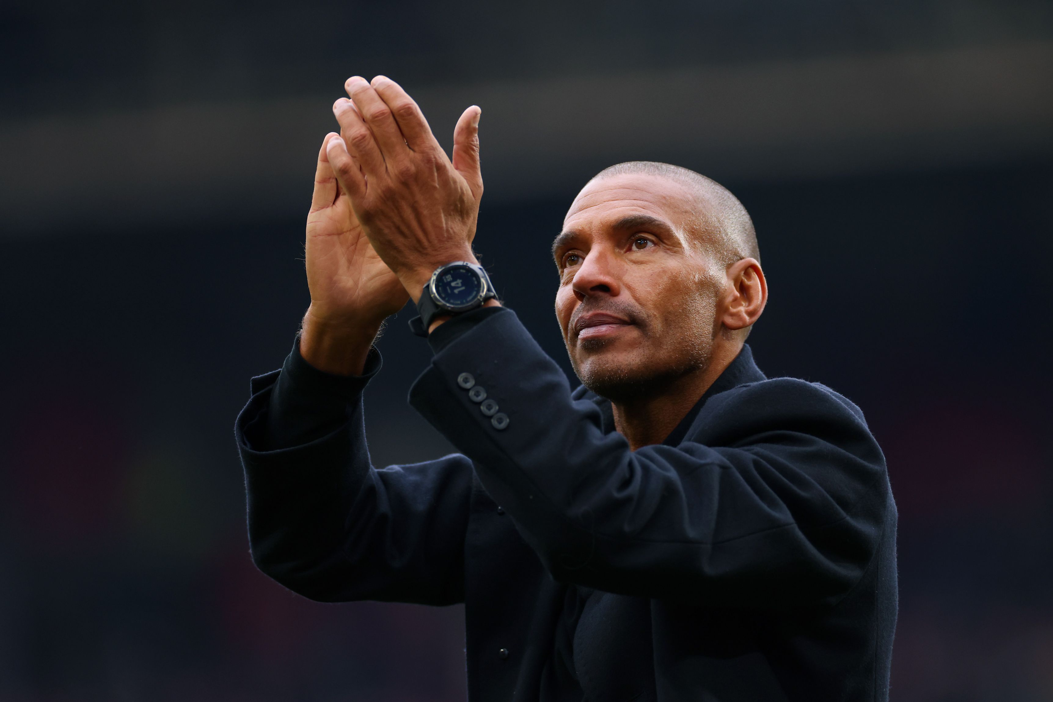 Stan Collymore applauds Nottingham Forest fans. (Photo by Marc Atkins/Getty Images)