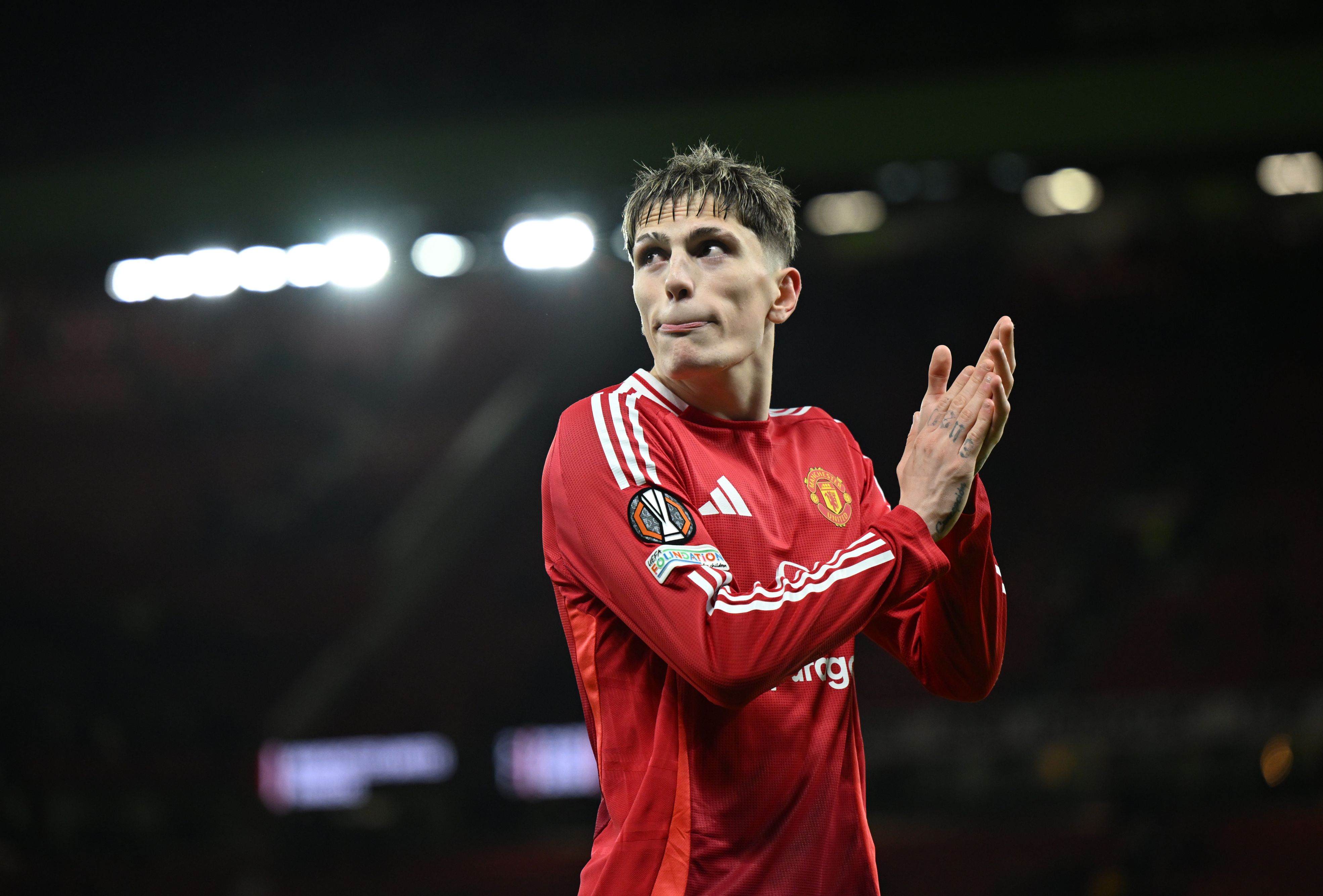 Alejandro Garnacho applauds the Manchester United fans.