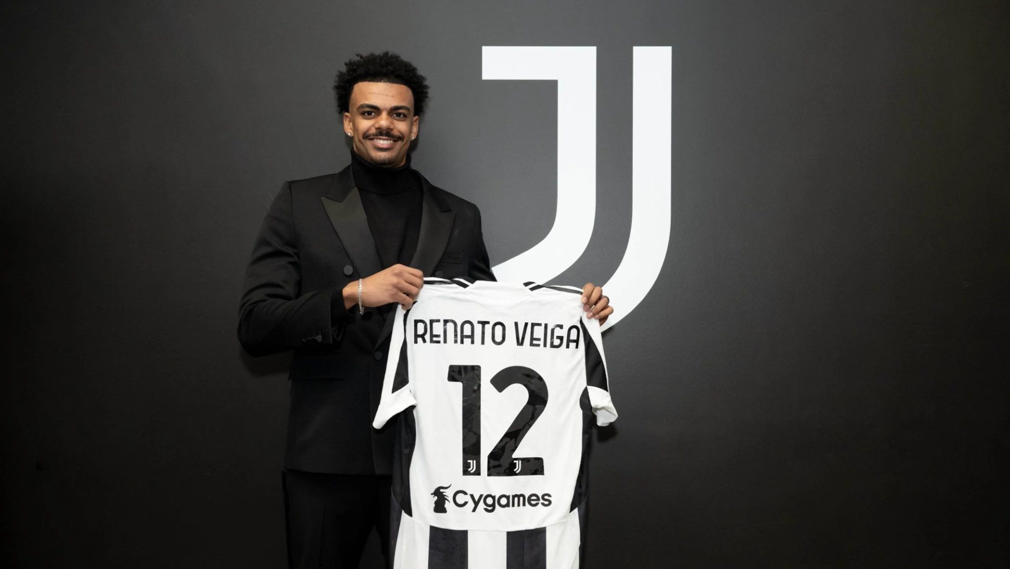 Renato Veiga smiles in his Juventus unveiling. 