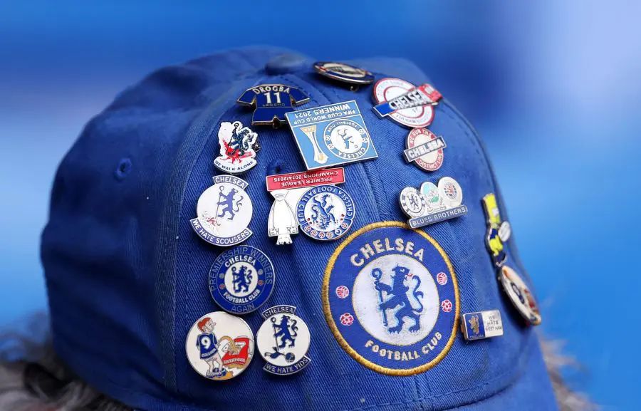 A hat covered in Chelsea badges.