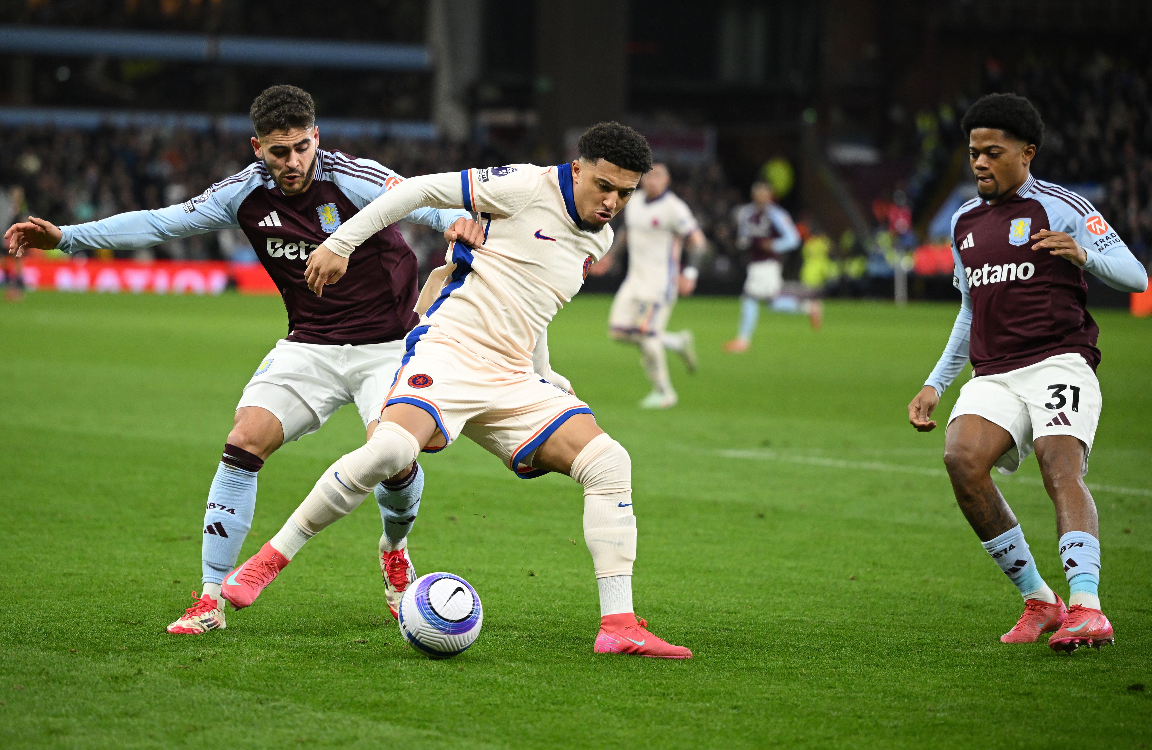 Jadon Sancho battles for possession against Aston Villa.