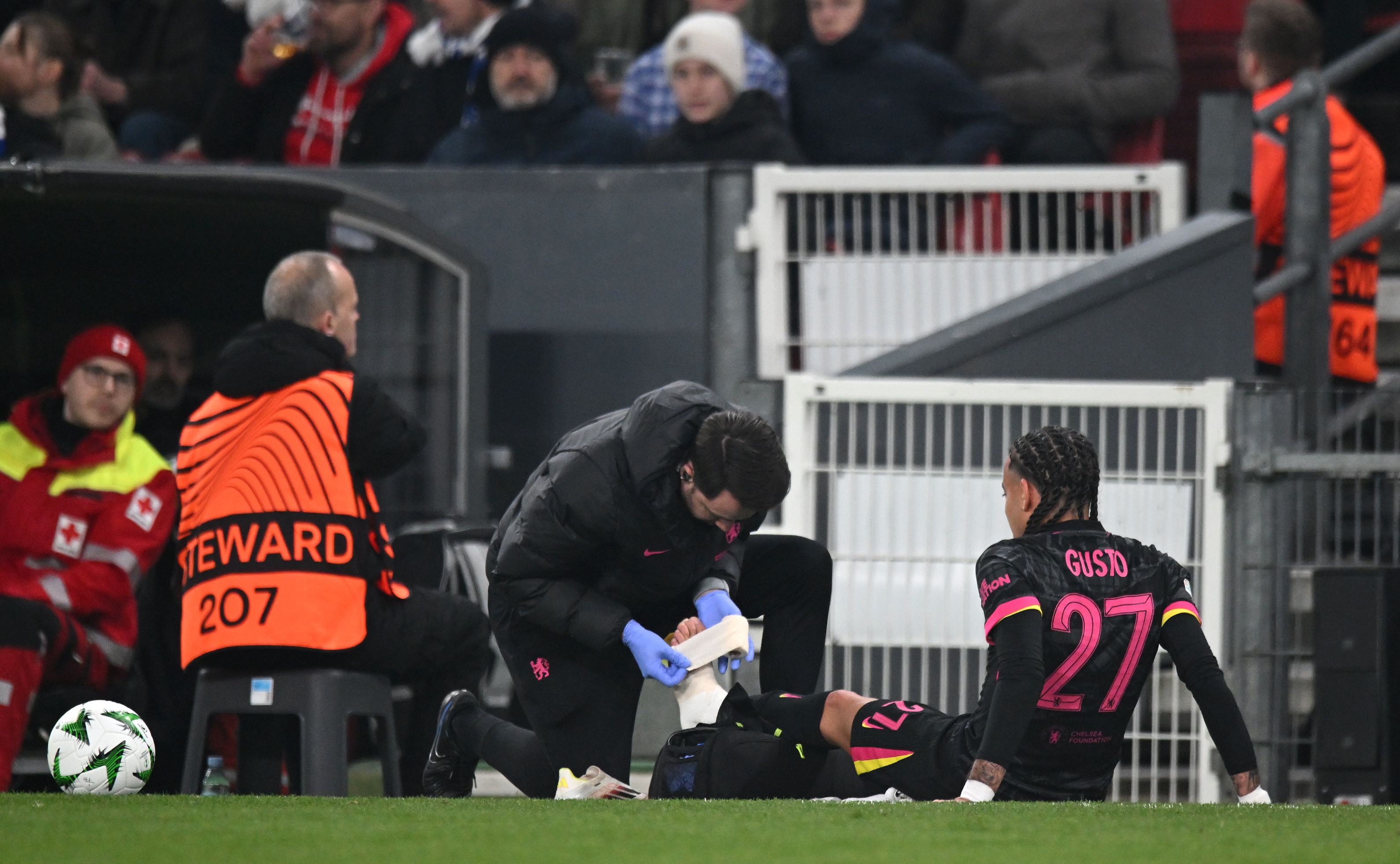 Malo Gusto gets treatment on the pitch.