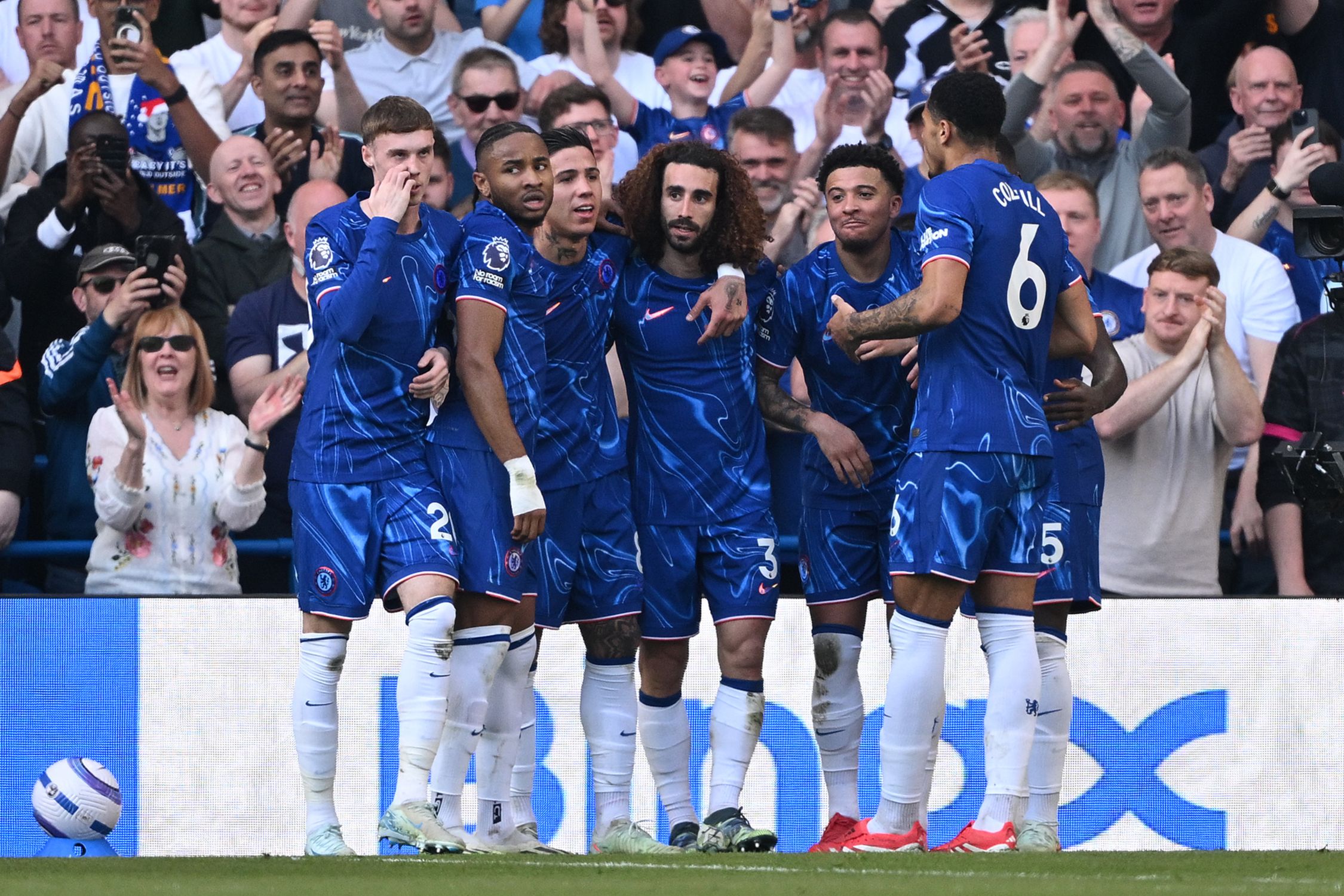 A Chelsea generic group huddle celebration.