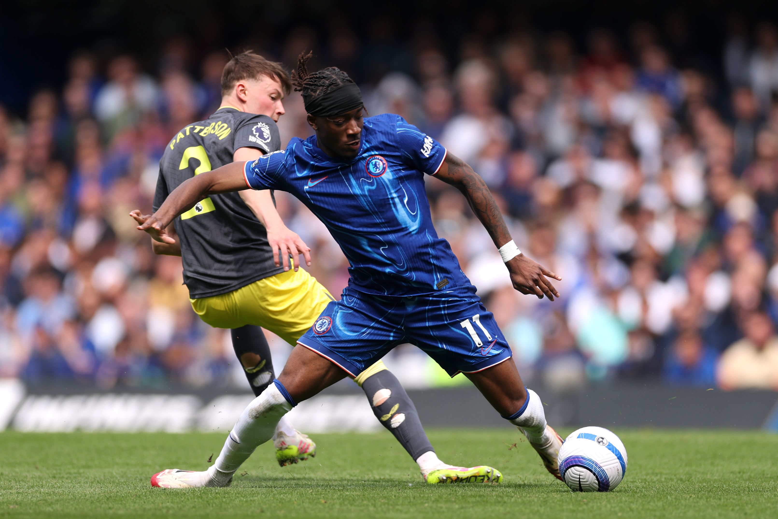 Noni Madueke battles for possession against Everton.