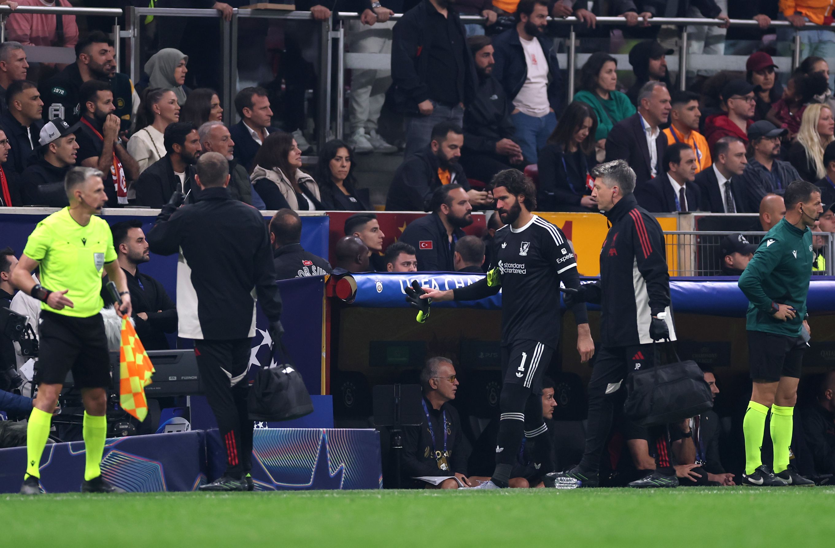 Alisson goes off injured against Galatasaray.
