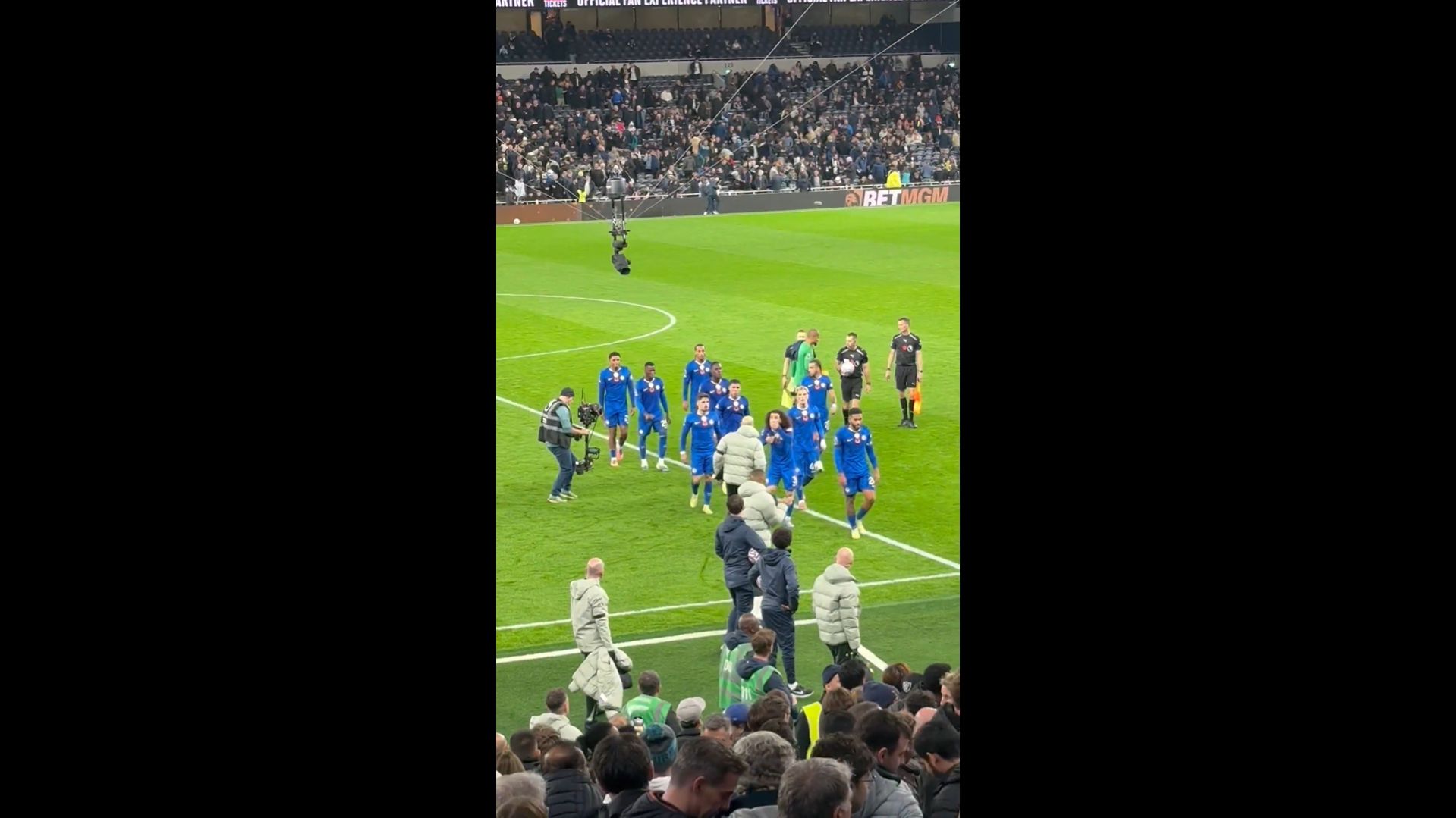 Reece James brings the players off at half time.