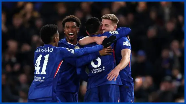 A generic group of Chelsea players celebrate with Liam Delap after his goal.