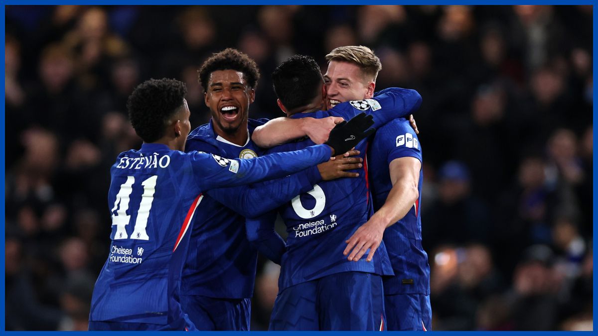 A generic group of Chelsea players celebrate with Liam Delap after his goal.