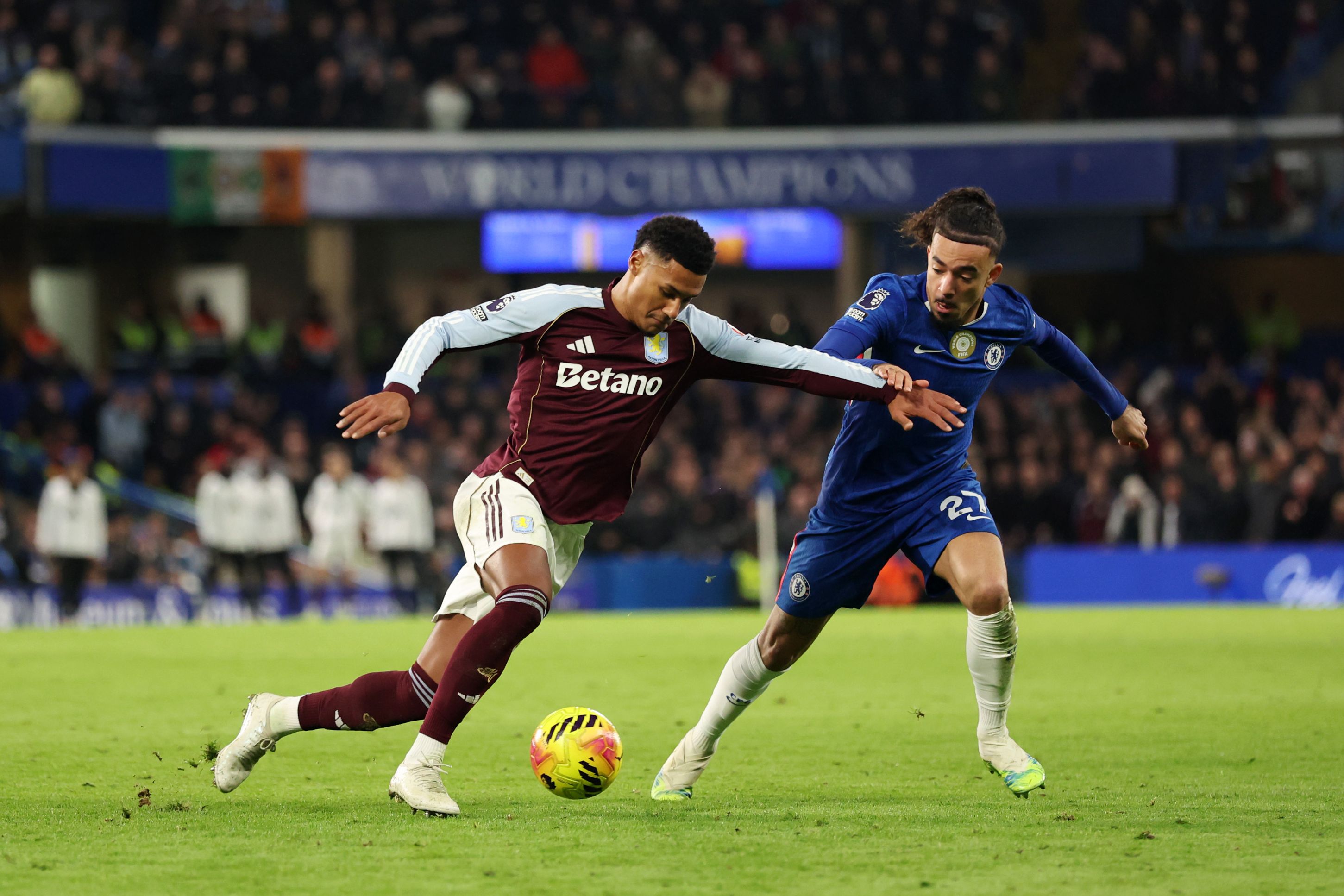 Malo Gusto battles for possession with Ollie Watkins.
