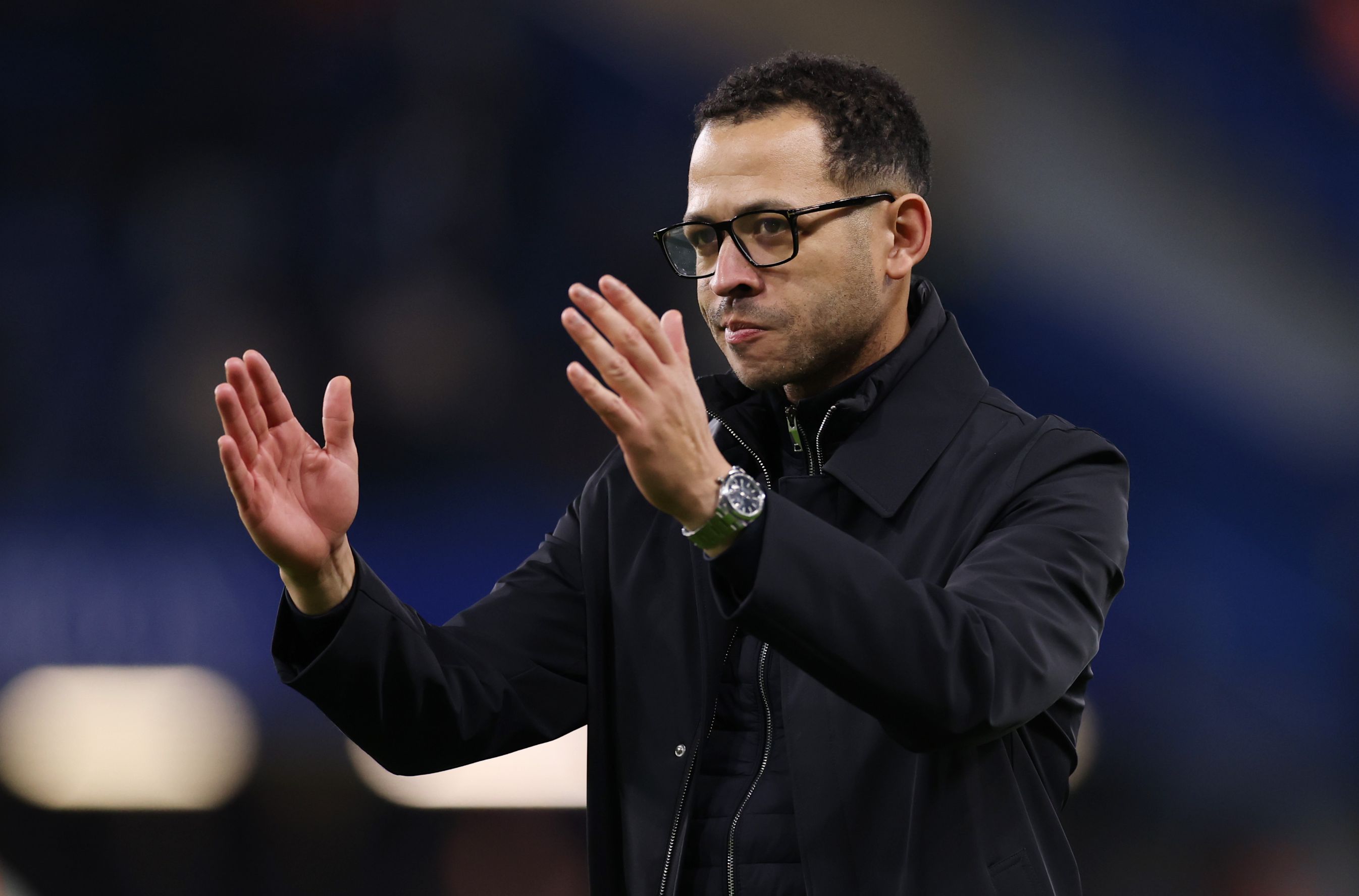 Liam Rosenior applauds the Chelsea fans.