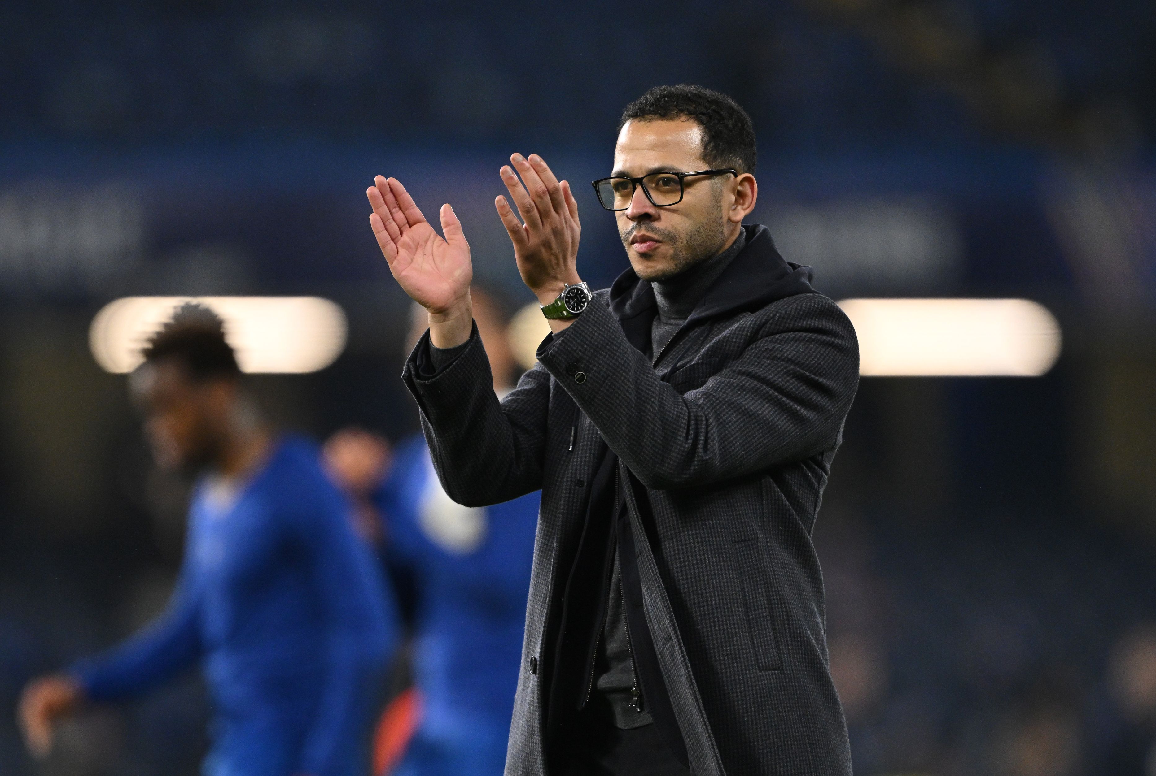 Liam Rosenior applauds the Chelsea fans.