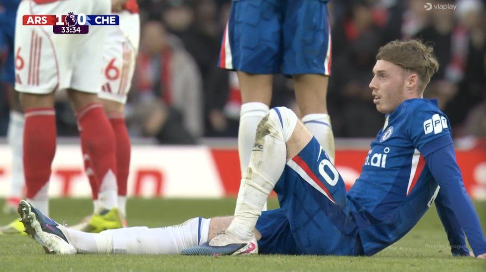 Cole Palmer lies on the turf and waits for treatment in the first half.