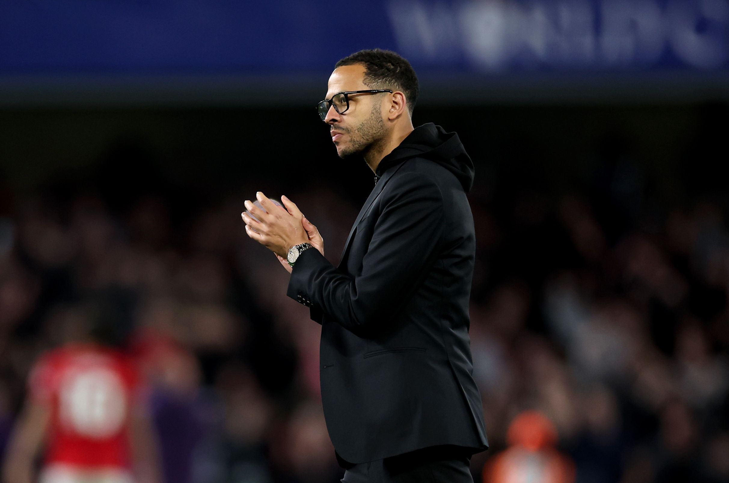 Liam Rosenior applauds the Chelsea fans.