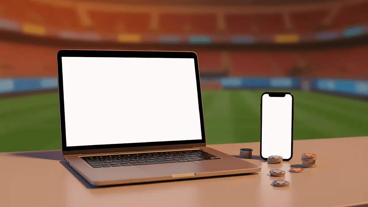Digital sports betting platform displayed on laptop and smartphone with stadium background
