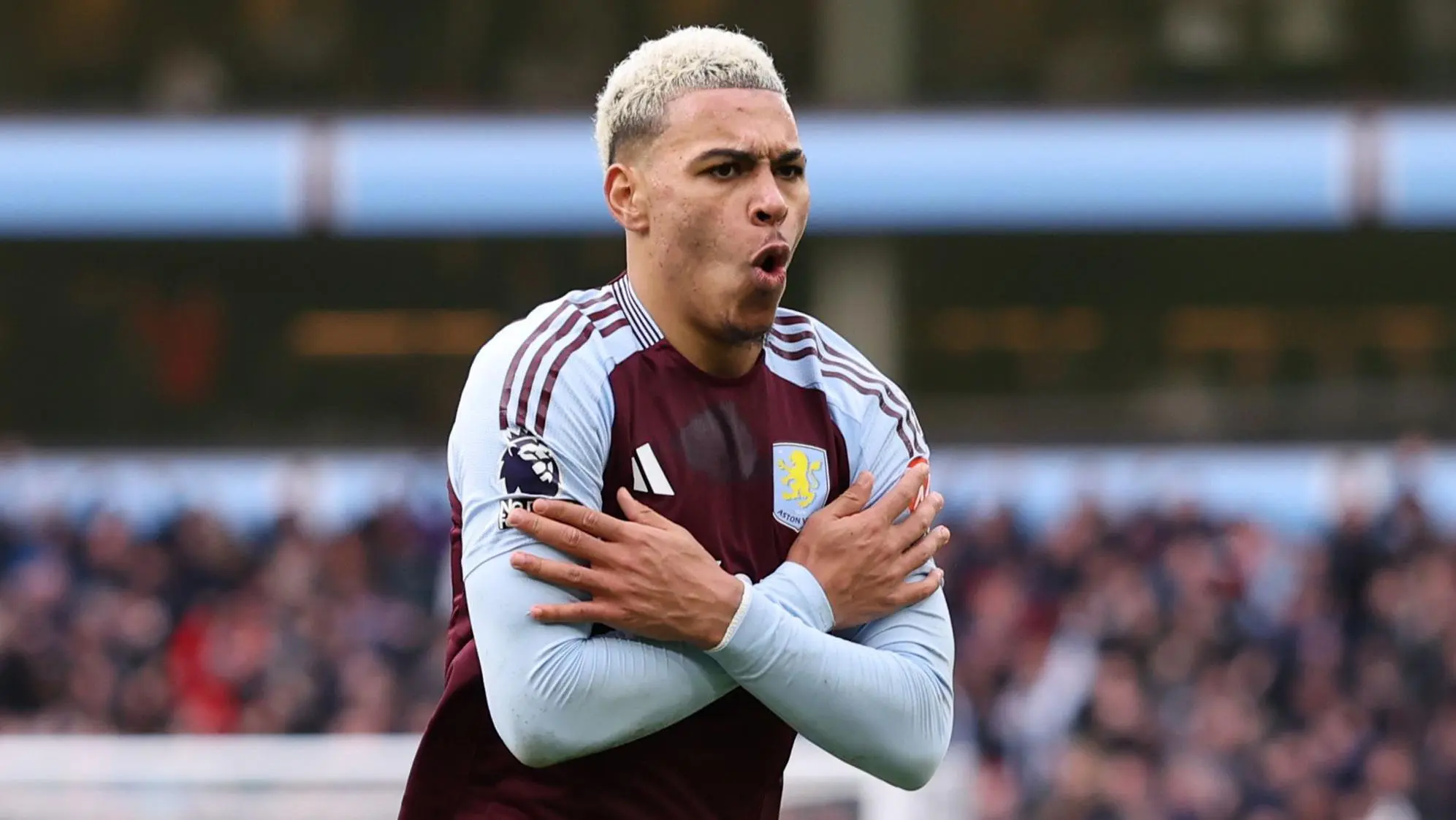Morgan Rogers celebrating in an Aston Villa kit during a football match