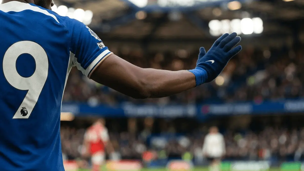 Chelsea jersey in commanding gesture blocking rival clubs, symbolizing transfer control