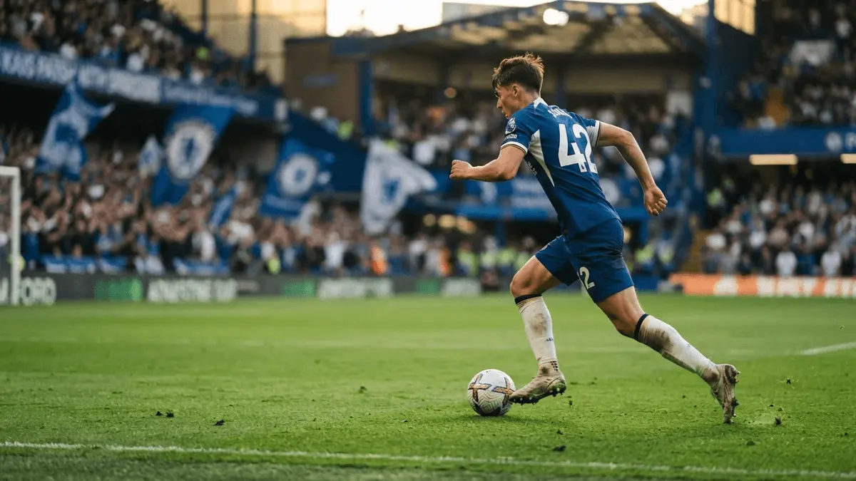 Young footballer in Chelsea blue kit dribbling at speed on Stamford Bridge pitch