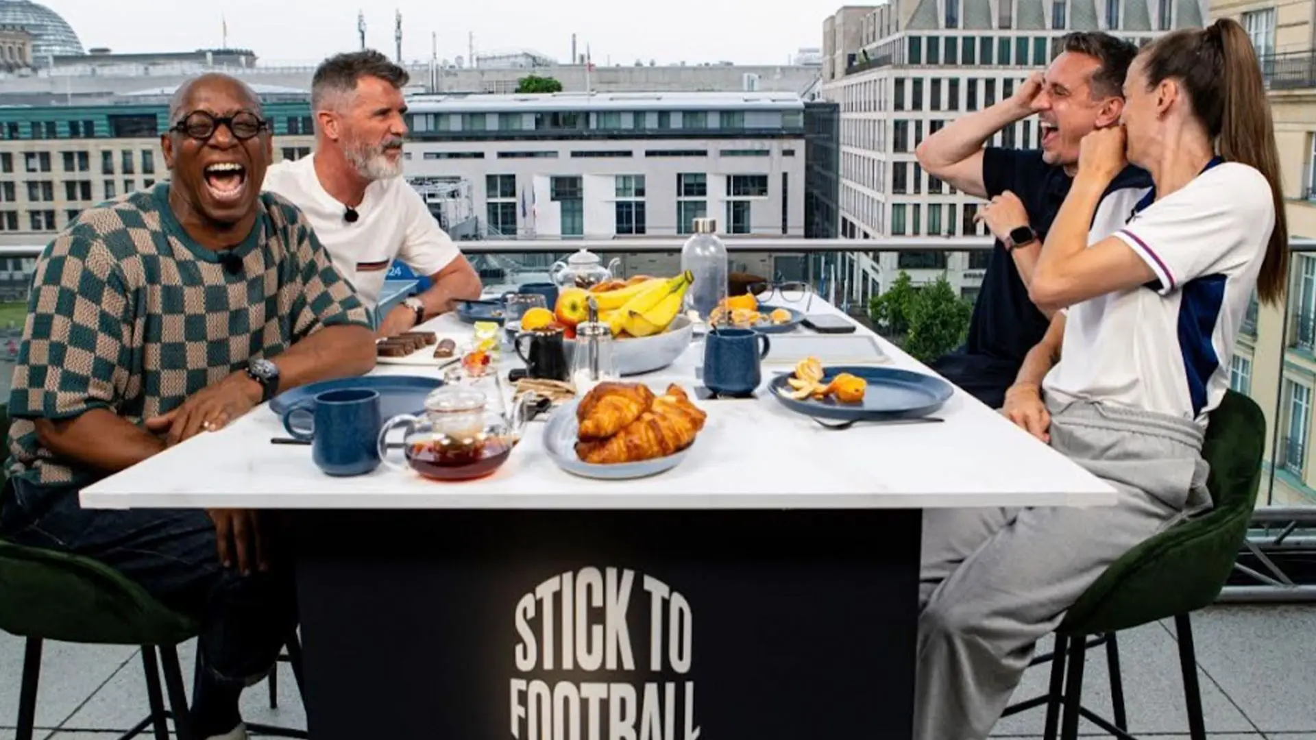 A lively discussion on the Stick to Football podcast featuring four hosts at a table with food.