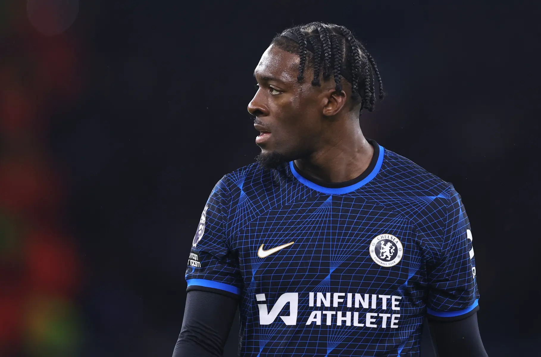 Axel Disasi in a blue Chelsea FC home kit with the Infinite Athlete sponsor logo