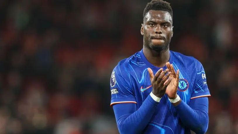 Benoit Badiashile wearing a blue Chelsea FC kit and clapping on the pitch