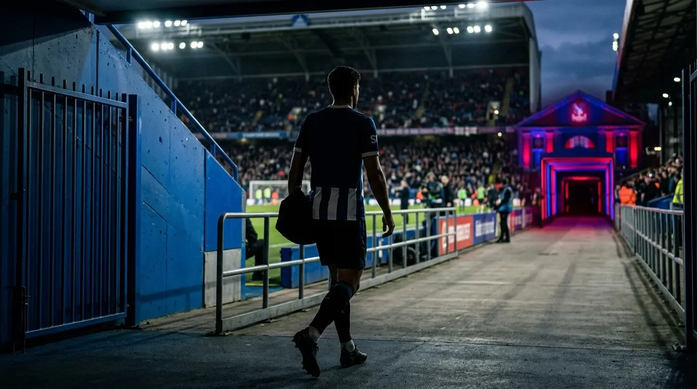 Football defender walking from Chelsea blue toward Crystal Palace red and blue stadium colors during a loan move
