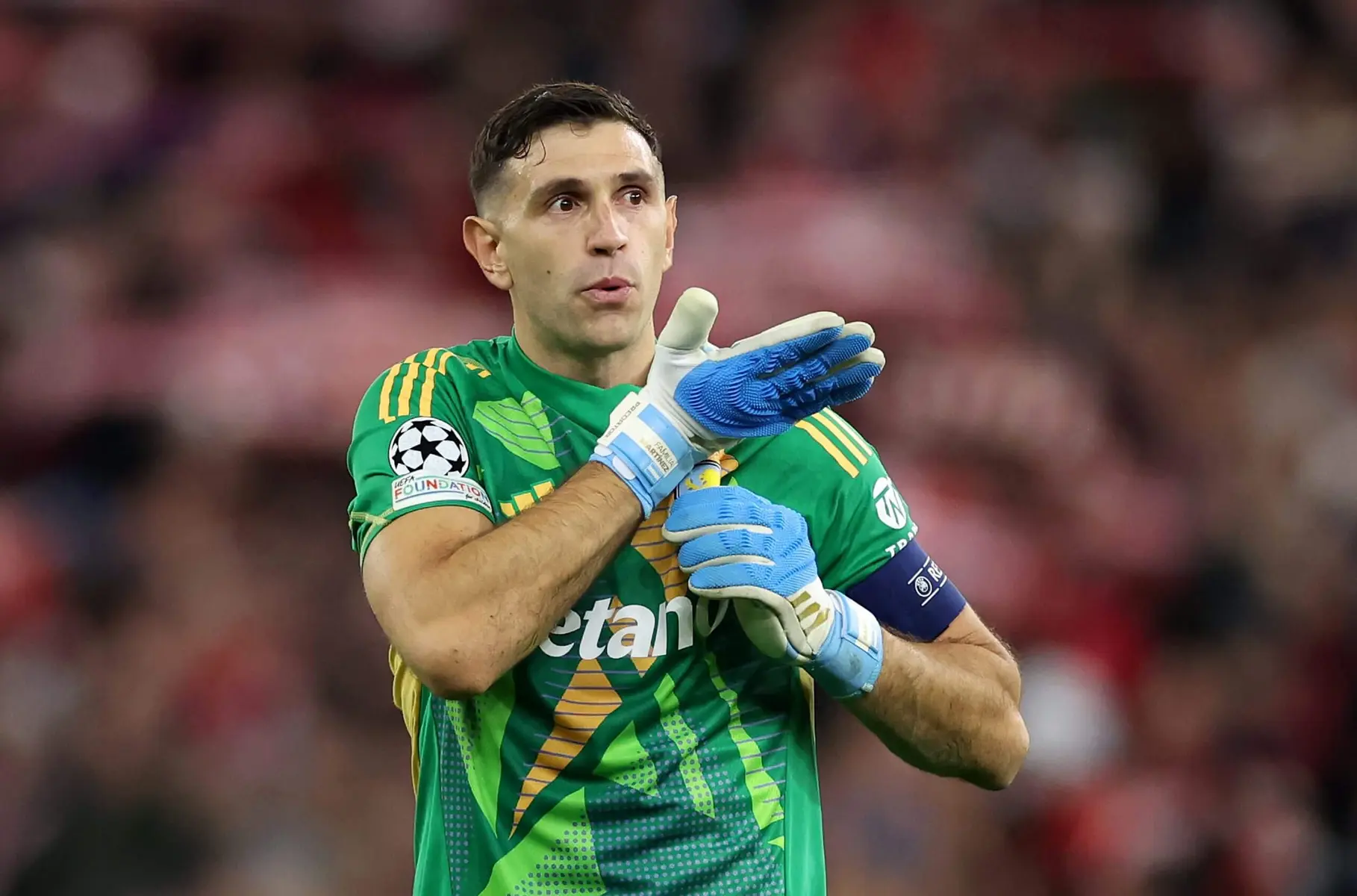 Aston Villa goalkeeper Emiliano Martínez wearing a green goalkeeper jersey and gloves during a match