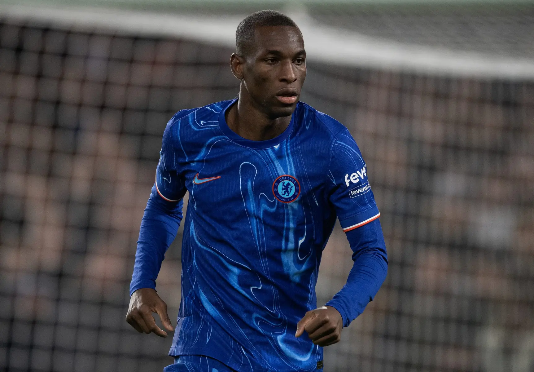 Nicolas Jackson wearing a blue Chelsea FC home kit on a football pitch