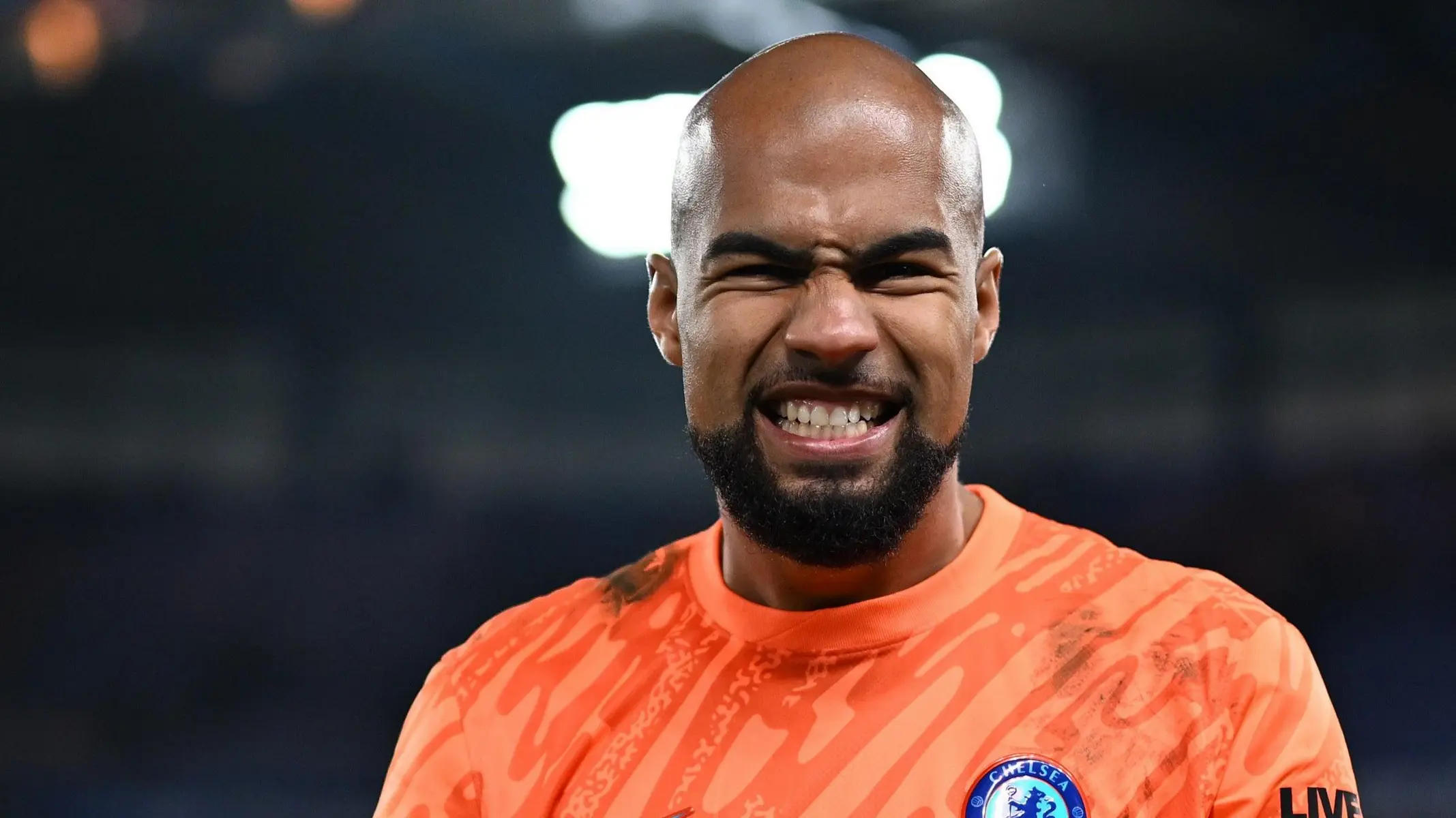 Close-up of Chelsea goalkeeper Robert Sanchez making a grimacing facial expression during a match