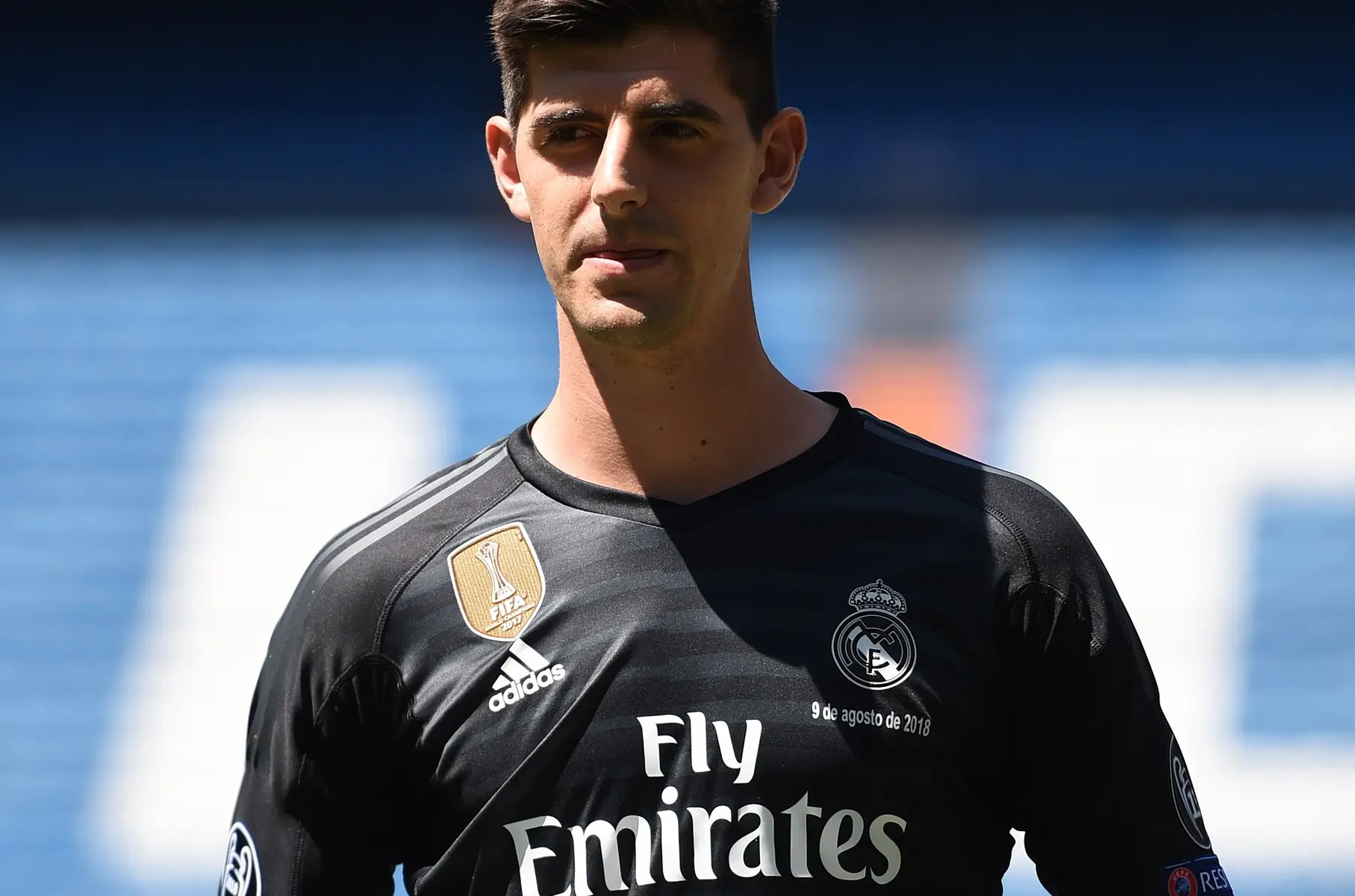 Thibaut Courtois wearing a black Real Madrid goalkeeper kit during a presentation event.