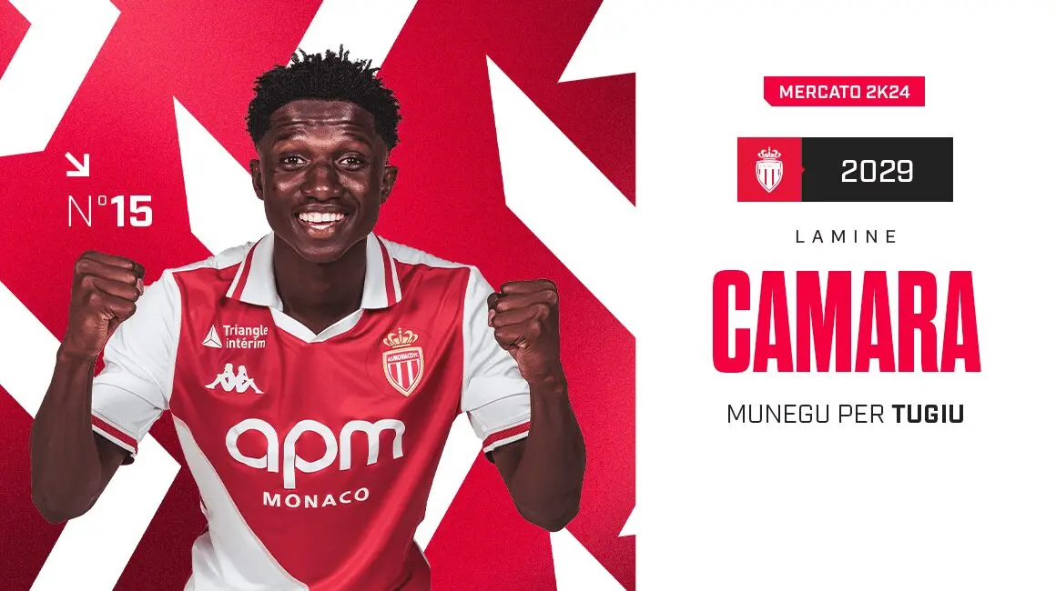 Lamine Camara wearing the AS Monaco red and white home kit, smiling and celebrating.