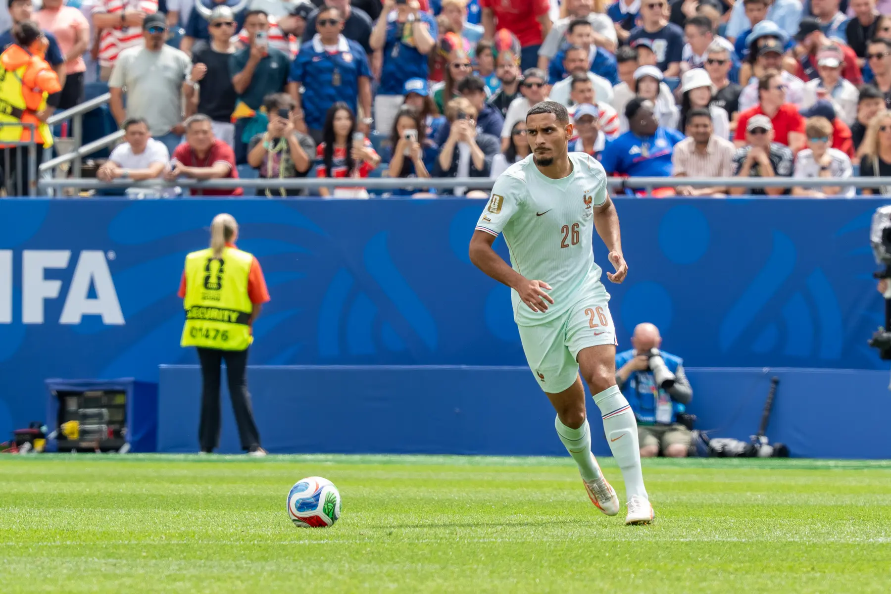 Maxence Lacroix in a white France national team kit playing during a match against Norway.