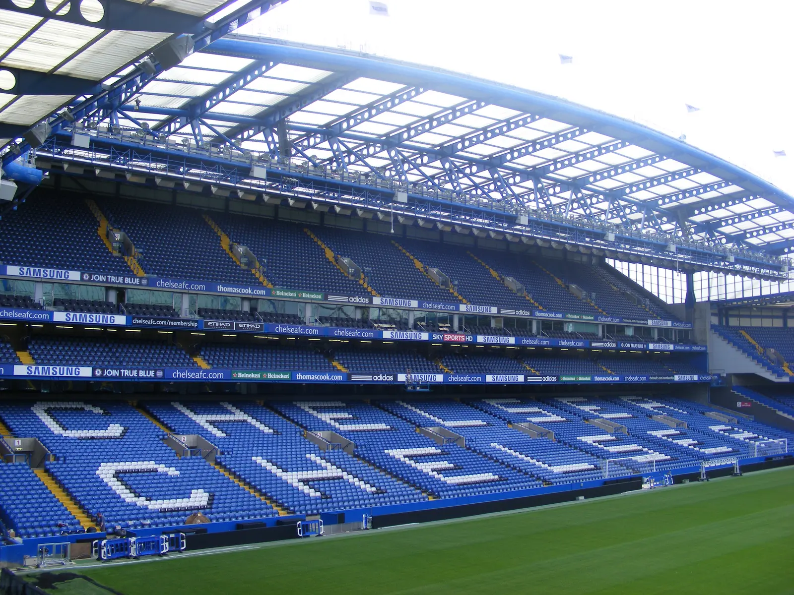 Wide view of the blue seats and stands at Stamford Bridge stadium.