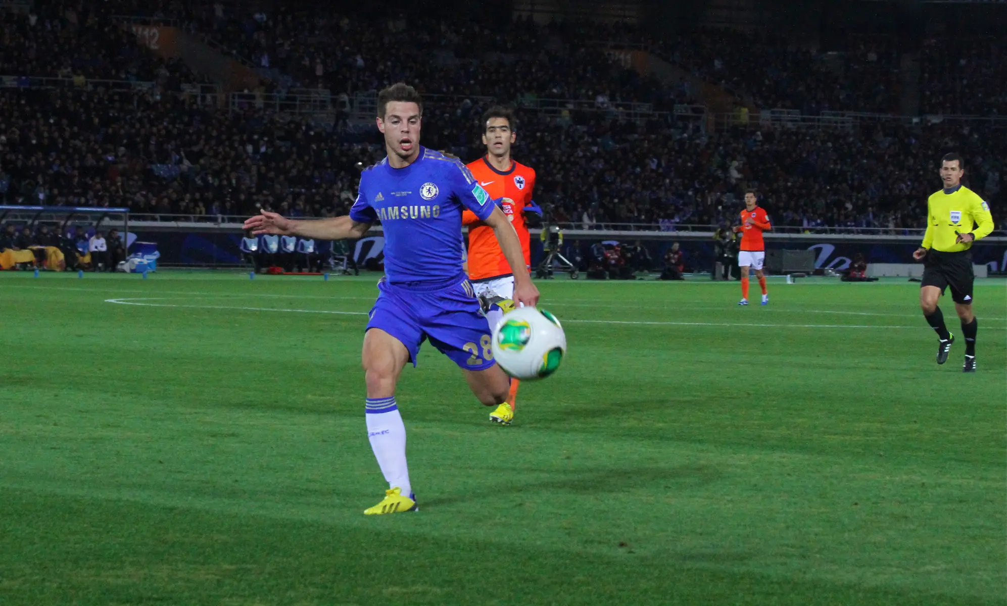 César Azpilicueta in a blue Chelsea kit controlling the ball during a football match.