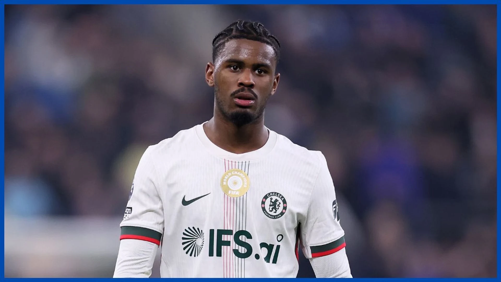 Jorrel Hato wearing a white Chelsea FC kit during a match.