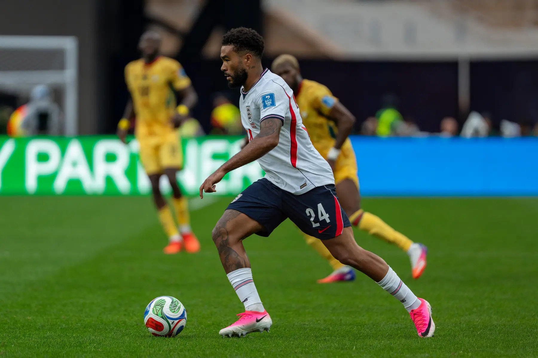 Reece James in an England national team kit controlling a football during a match.